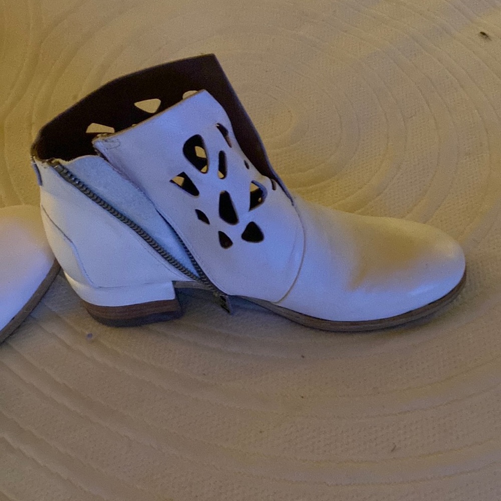 Unworn booties off white in color